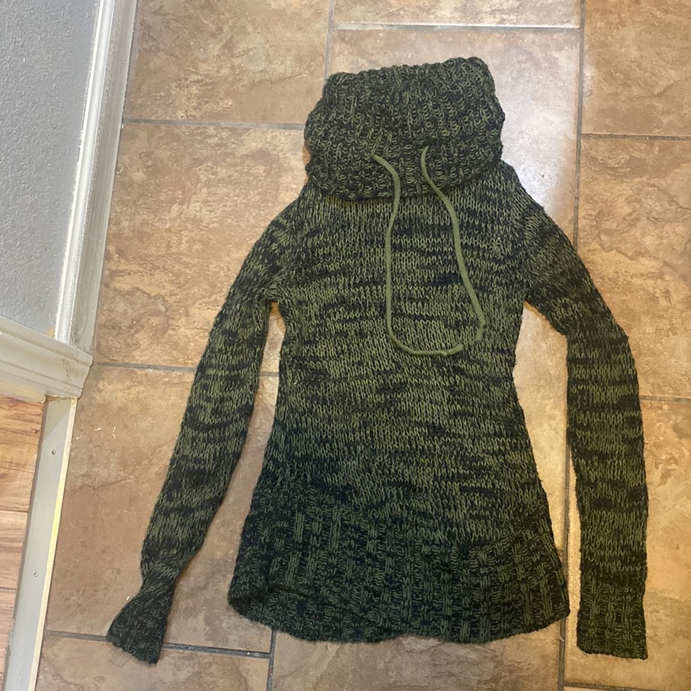 The color is avocado green black sweater with a turtleneck